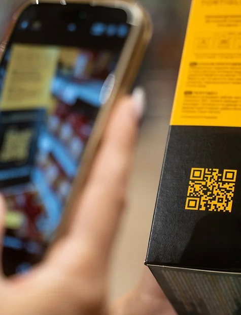 Phone scanning the QR code on a product box for traceability